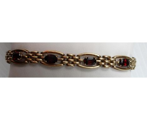 A 9ct yellow gold seven-stone oval-cut ruby bracelet on mesh links, each stone 5 x 7mm approximately, 20 cm hallmarked for Bi