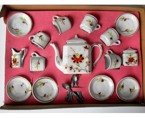 A late 19th century / early 20th century German porcelain miniature doll's tea set decorated with painted red floral sprays a