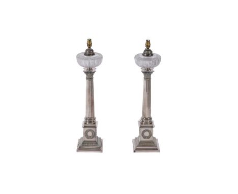 A PAIR OF SILVER PLATED COLUMNAR OIL LAMPSLATE 19TH CENTURY AND LATER CONVERTED TO ELECTRICITYEach 66cm high excluding fitmen