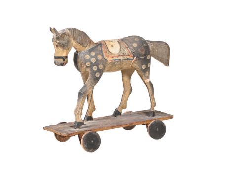 A VICTORIAN PAINTED WOOD 'FOLK ART' PULL ALONG HORSE LATE 19TH CENTURY The automaton with nodding head as the front wheels re