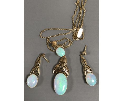 A 15ct gold opal pendant on chain together with the matching pair of earrings, 15.4g gross. (3) CONDITION REPORT: Earrings wi
