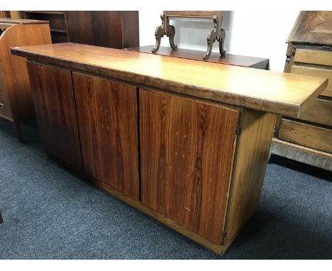 A Danish rosewood low sideboard by Skovby, with fitted interior and enclosed by three panel doors, width 190 cm 