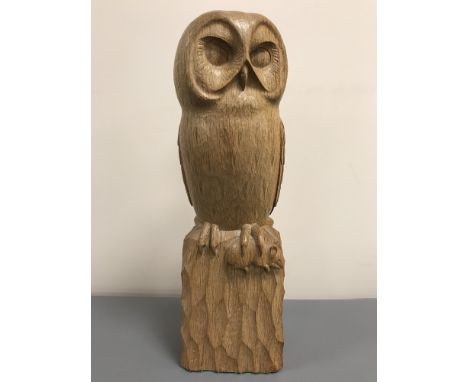 A Robert 'Mouseman' Thompson of Kilburn carved oak owl, carved as a perched owl holding a mouse in its talon upon a rockwork 