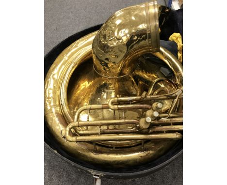 A brass sousaphone, cased. CONDITION REPORT: No apparent maker's name. 