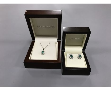 An 18ct white gold emerald and diamond cluster pendant on chain, together with the matching pair of 18ct white gold emerald a