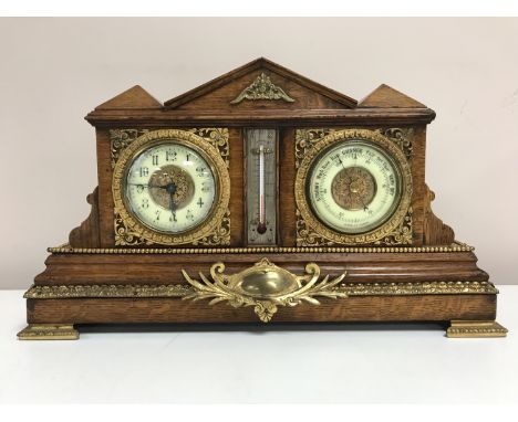 A late Victorian double clock barometer thermometer, oak framed and mounted in brass, width 46 cm.