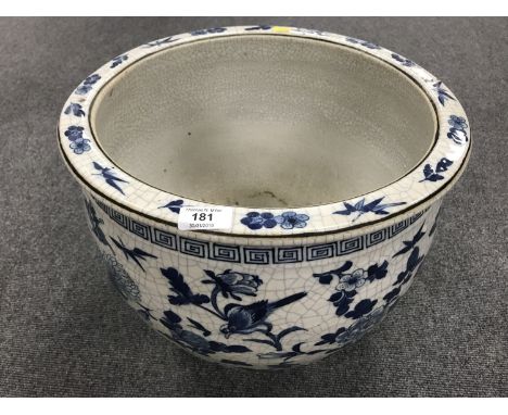 A Chinese crackle glazed blue and white planter, diameter 40 cm. CONDITION REPORT: Crazed throughout. Numerous small firing f