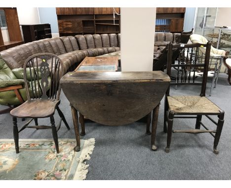 A George III oak gate leg table on pad feet, width 100 cm, together with a rush seated country chair and a single Windsor cha