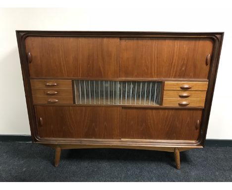 A mid 20th century teak multi drawer sideboard, with sliding panel doors, width 154 cm 