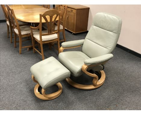 A green leather Himolla relaxer chair and stool. (2)