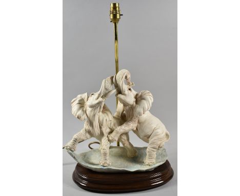 A Reproduction Resin Table Lamp in the Form of Two Elephants Fighting, 49.5cm high 