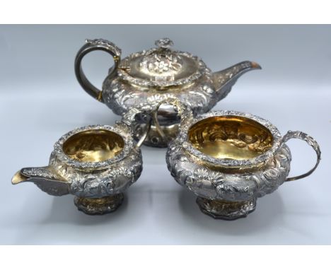 A George IV Silver Three Piece Tea Service comprising teapot, two handled sucrier and cream jug all with embossed decoration 