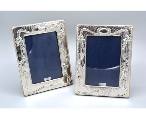 A Pair Of 925 Silver Art Nouveau Style Rectangular Photograph Frames of embossed stylised form 18.5 x 14 cms 