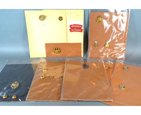 A Collection Of Cap Badges to include Army Educational Corps and others on nine cards 
