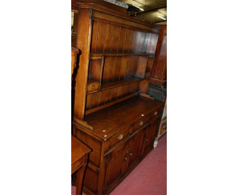 An 18th century style joined and moulded oak dresser Condition Report / Extra Information Some light surface fading to top su