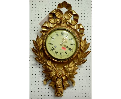 A floral giltwood decorated convex wall clock, having twin winding holes (lacking glass)