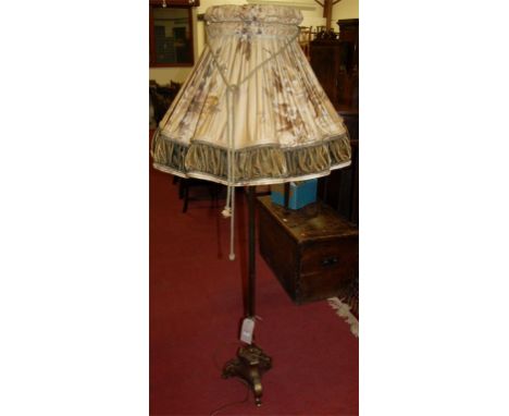A contemporary brass standard lamp, having a floral pleated shade
