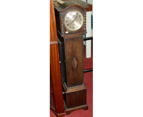 An early 20th century oak striking and chiming grandmother clock