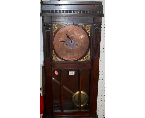 An early 20th century walnut cased droptrunk wall clock