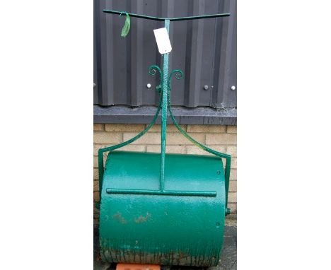 A green painted cast and wrought metal garden roller