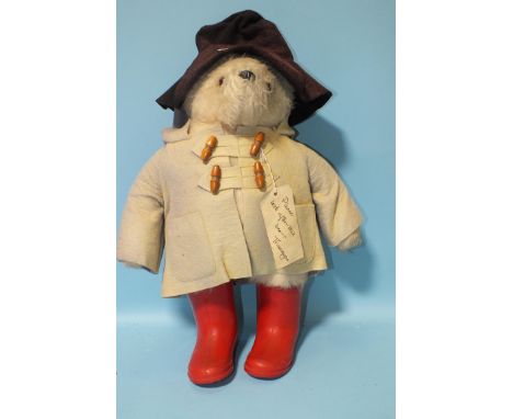 A 1980 Film Fair Paddington Bear, with felt hat and duffle coat, (faded) and red wellies, 50cm.