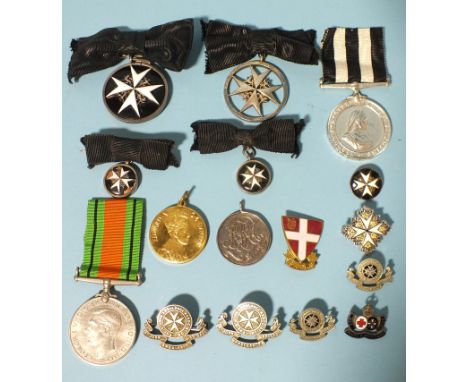 The Order of St John, two breast badges, (2nd and 3rd types), with two miniatures, (one damaged), Service Medal, four St John