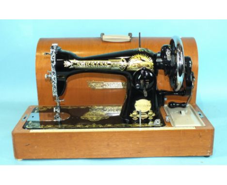 A cased manual sewing machine by 'The Normann Sewing Machine Company'.