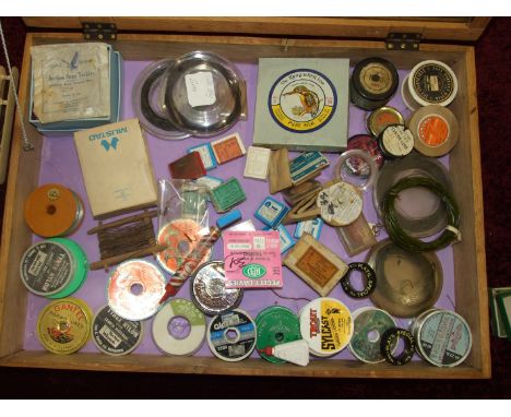 A collection of fly lines, vintage gut on spools, hooks, together with five wood and one K P Morritt line winders.