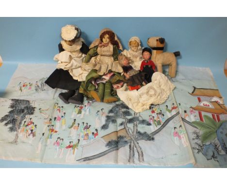 Three 20th century ceramic shoulder-head dolls, two Dutch dolls, a soft toy terrier and a Japanese silk panel of female figur