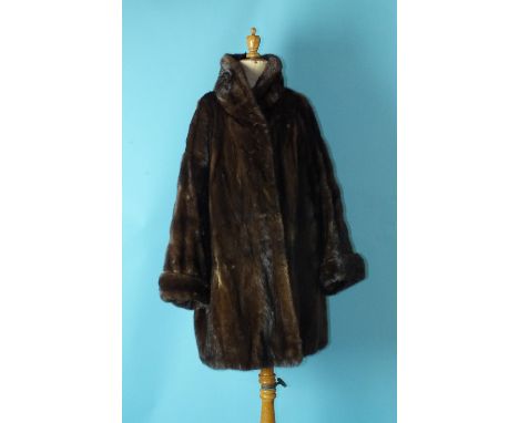 A lady's brown mink coat, three-quarter length, with turned-up cuffs and roll neck, labelled for Kenneth Cross, Newcastle-upo