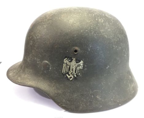 WW2 Third Reich M35 Heer Re-issue Steel helmet. Single decal. Over painted with rough fled grau paint with traces of whitewas