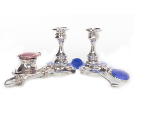 PAIR OF GEORGE V SILVER AND ENAMEL DWARF CANDLESTICKSmaker Henry Clifford Davis, Birmingham 1926, the circular bases inset bl
