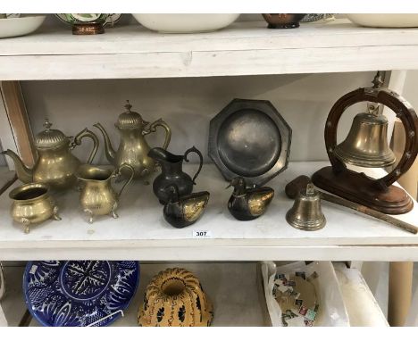 A shelf of brass and pewter including. bell/gong etc.