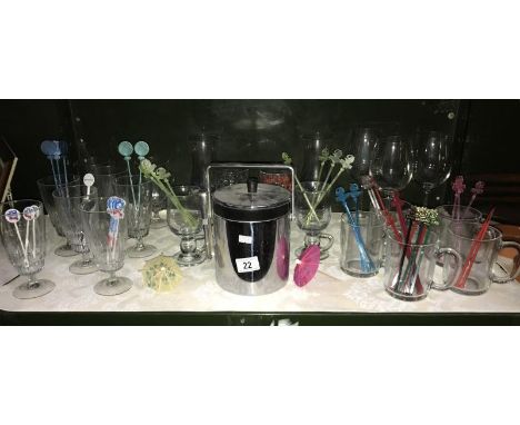 A shelf of drinking glasses, ice bucket etc.