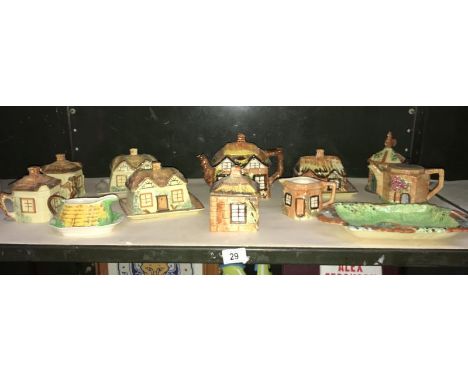 A shelf of Price Kensington, Royal Winton cottage ware teapots, butter dishes etc a/f