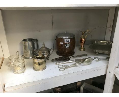 A shelf of silver plate and a biscuit barrel