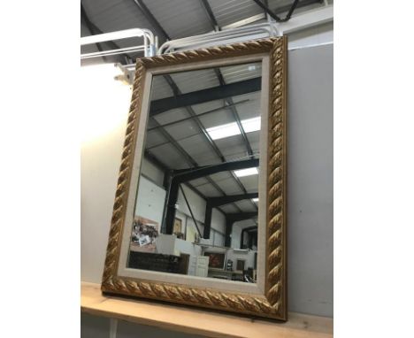 A framed gold painted mirror