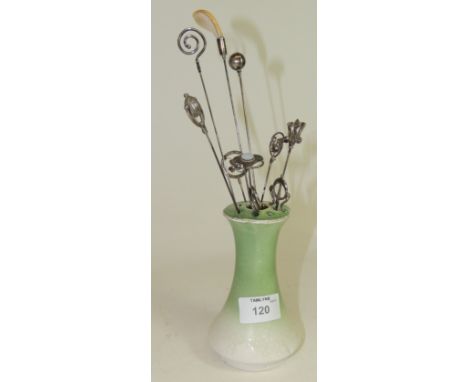 A group of ten silver finial hat pins mostly Art Nouveau form, including a thistle set with mauve glass "flowerhead"; another