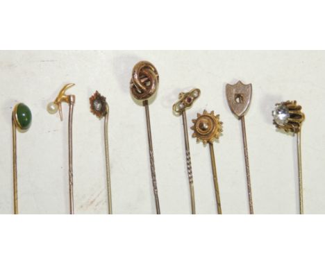 A 9ct gold pearl set stick pin together with seven other gold and gold metal decorative stick pins (8)