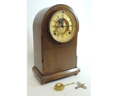 A Victorian mantel clock by Ansonia having gilt metal dial with visible escapement, two train movement striking on a gong and