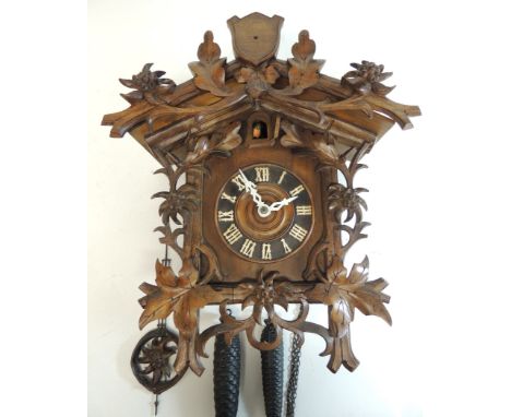 A late 19th Century Black Forest Cuckoo Clock in traditional chalet style case with edelweiss decoration and with edelweiss p