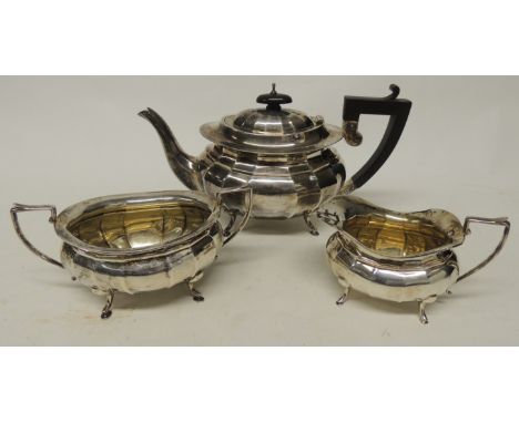 A silver three-piece tea service, the teapot, milk jug and sugar bowl all hallmarked for Birmingham 1929.  The teapot with eb