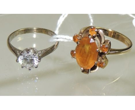 A 9ct gold dress ring set with a central oval faceted citrine within a surround of six small citrines, ring size N and a 9ct 