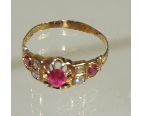 An 18ct gold Victorian ring with claw set central ruby, two small diamonds either side and a single ruby to each shoulder.  R