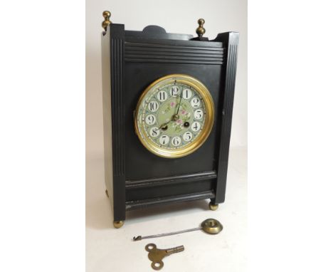 A late 19th Century Aesthetic movement mantel clock having circular enamel dial painted with flowers, two train movement stri