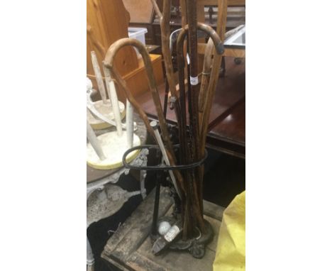 A stick stand, containing various walking sticks, etc.