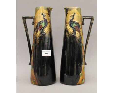 A pair of Frederick Rhead Art Nouveau pottery ewers. 30.5 cm high; 10.5 cm diameter.