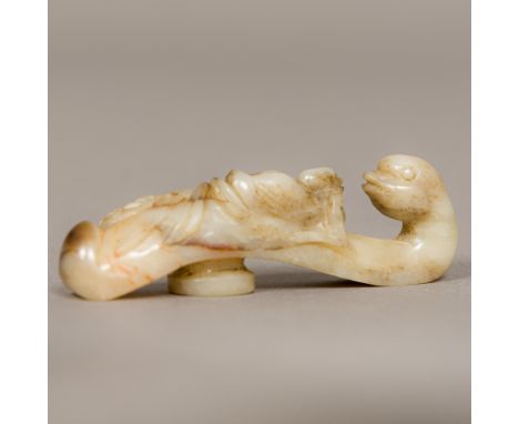 A Chinese carved celadon and russet jade belt hook, worked as an Asiatic duck and its chick.  7 cm long.