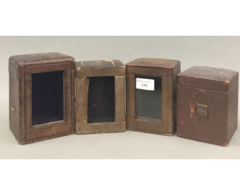 Four 19th century carriage clock cases.  Largest 15 cm high; 10.75 cm wide; 10.5 cm deep.