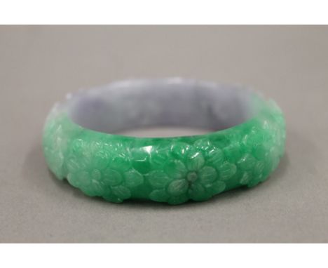 A carved jade bangle. 7.5 cm diameter.